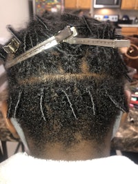 a woman's hair with a pair of scissors on it