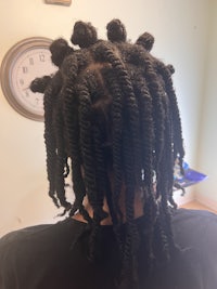 a woman's head with dreadlocks on it