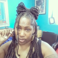 a woman with dreadlocks posing in front of a mirror