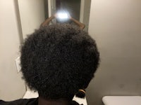 the back of a woman's hair in a mirror