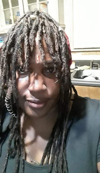 a woman with long dreadlocks in a kitchen