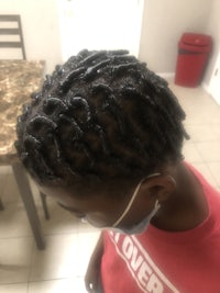 a person with dreadlocks in a kitchen